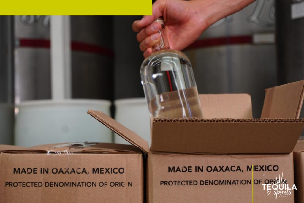 Detail of mezcal bottles being packed at Tequila Spirits Mexico, creating a Mezcal Private Brand.